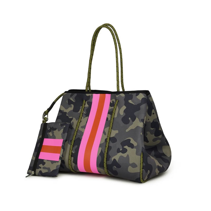 A camouflage tote bag with olive green handles and trim, featuring vertical stripes in pink, orange, and red on the front, shown on a white background with a matching zip pouch.