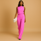 Sleeveless halter jumpsuit for women with high waist, wide legs, and decorative bow detail, perfect for summer dinners and evening occasions.